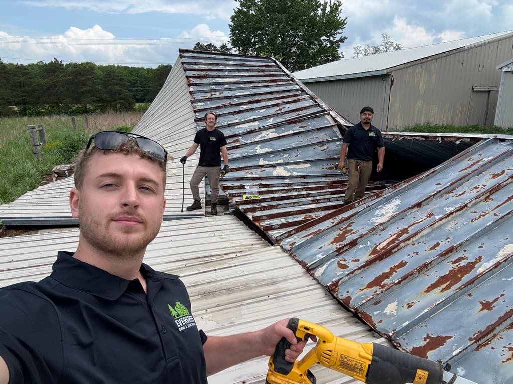 Evergreen crew demolishing a large barn