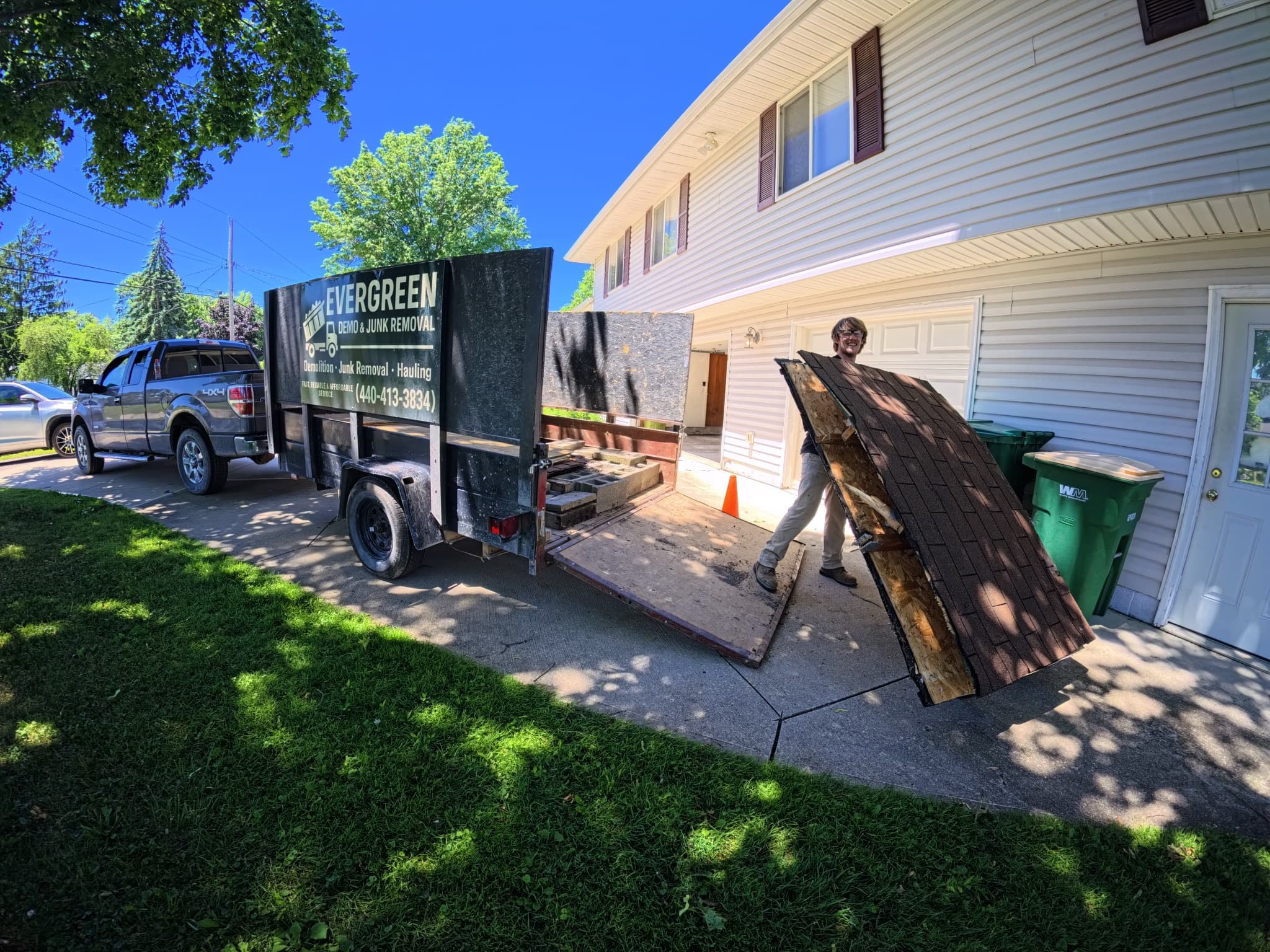 Evergreen Demo & Junk Removal truck parked at a residential job