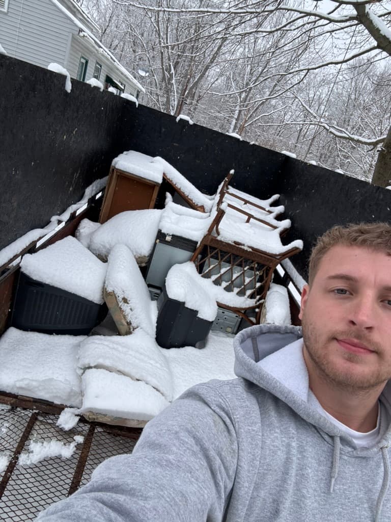 Evergreen crew hauling furniture in winter conditions — year-round junk removal service